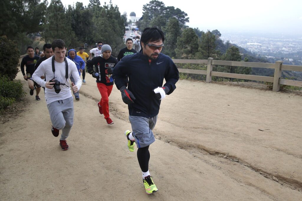 Boxer Manny Pacquiao, of the Philippines, runs along the trail at Griffith Park, Friday, April 10, 2015, in Los Angeles. Pacquiao is scheduled to fight Floyd Mayweather Jr. in a welterweight title fight in Las Vegas on May 2. (AP Photo/Jae C. Hong)