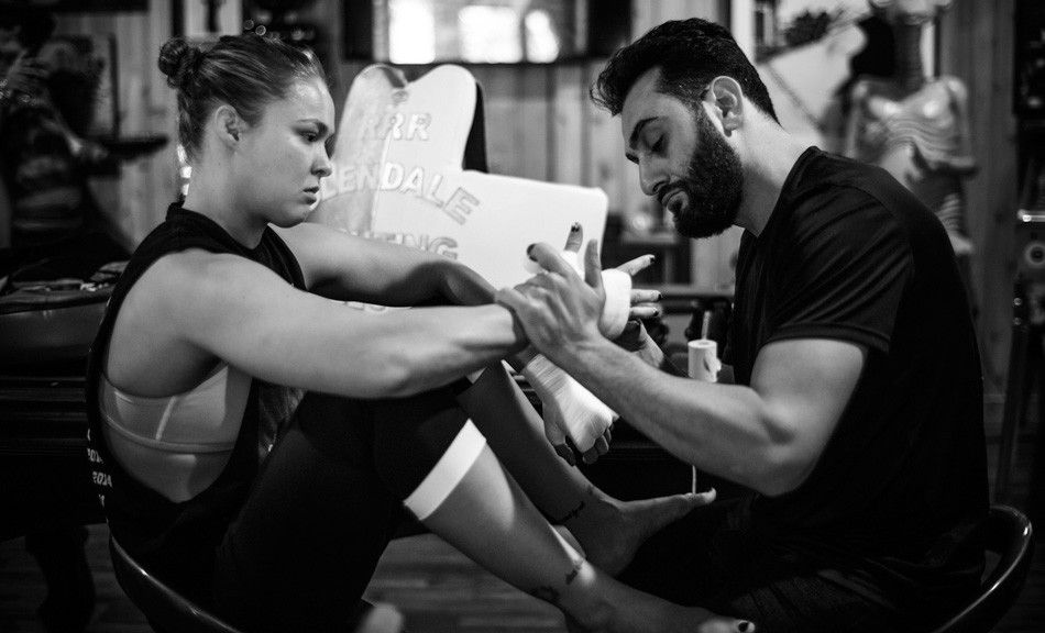 Ronda Rousey gets her hands wrapped by her coach, Edmond Tarverdyan.