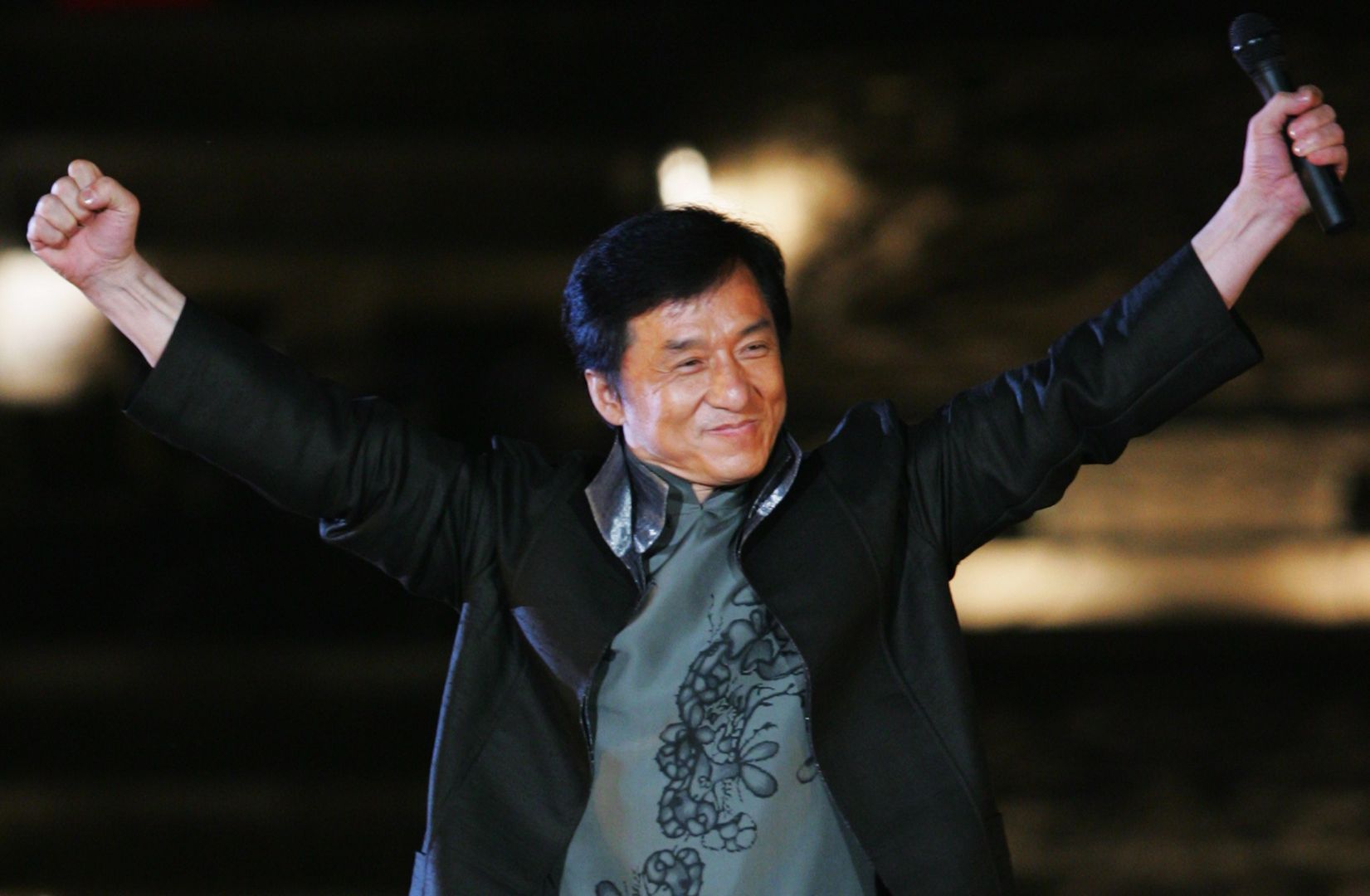 BEIJING - APRIL 30: Hong Kong's star Jackie Chan performs during the Award-giving Ceremony for the fourtth Olympic Songs Competition at the illuminated Worker People's Cultural Palace, the Imperial Ancestral Temple inside the Forbidden City, on April 30, 2008 in Beijing, China. Various activities, including an international long distance race, a song festival, a grand evening and an international speed-walking race, will be held in Beijing to celebrate the 100-day mark which falls on April 30. (Photo by Feng Li/Getty Images)