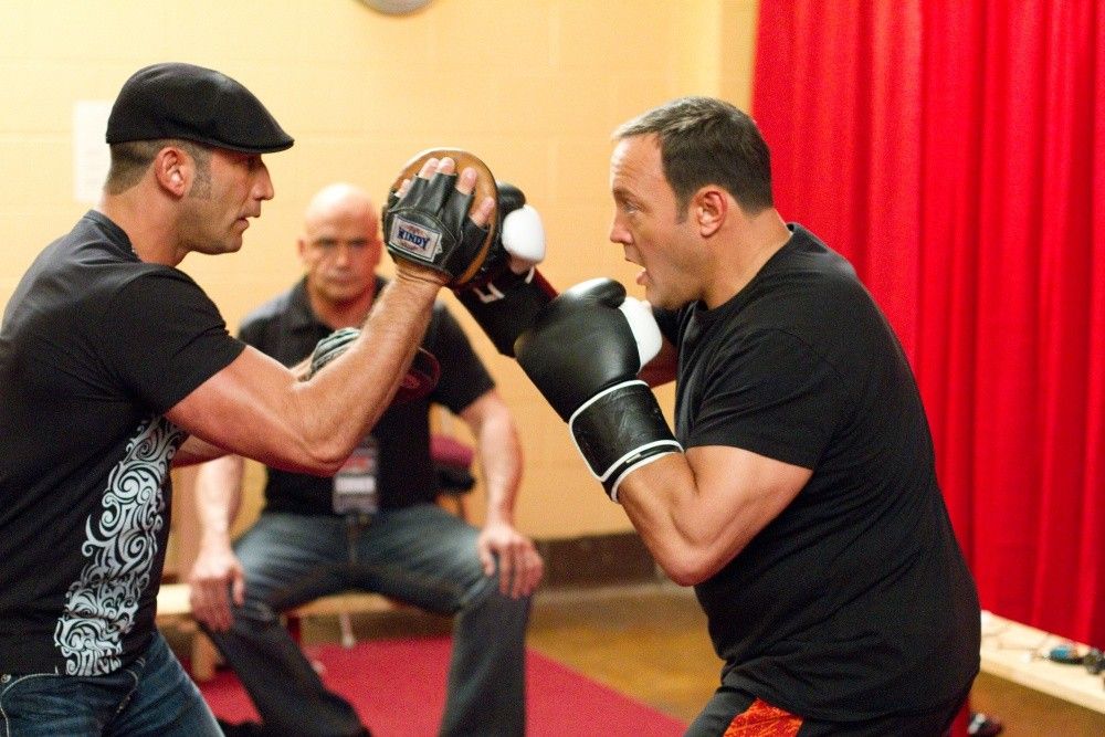 Mark Dellagrotte training Scott Voss (Kevin James) with Niko (Bas Rutten) looking on in Columbia Pictures' HERE COMES THE BOOM.