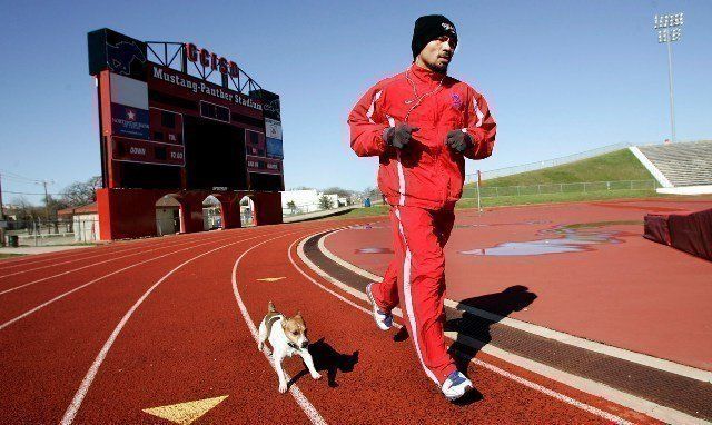 3/9/10,Dallas,Texas --- "DOUBLE PACMAN" --- Seven-time world champion and "Fighter of the Decade" Manny "Pacman" Pacquiao takes a morning run with his dog 'Pacman' Tuesday morning for his upcoming World Welterweight championship against challenger Joshua Clottey on Saturday,March 13 at Cowboys Stadium in Arlington,Texas on HBO Pay-Per-View. --- Photo Credit : Chris Farina - Top Rank (no other credit allowed) copyright 2010